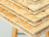 Ein Stapel Holzplatten liegt auf einem Tisch.