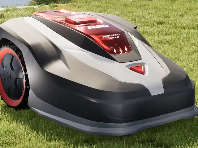 Ein Rasenroboter mäht Gras auf einer Wiese. Text: "AL-KO Robolinho 1200 W".
